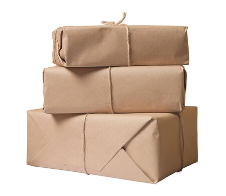 parcel wrapped with brown paper tied with rope isolated on white background の写真素材