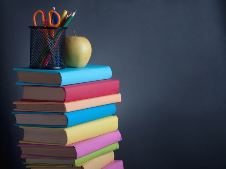Books on the background of the school boardの写真素材