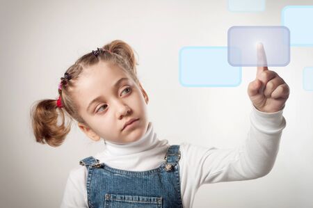 child pressing a touchscreen button の写真素材