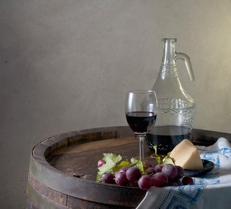Red wine, assorted cheeses, bread and grapes in a still life setup  の写真素材