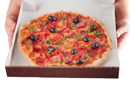 hands holding a box of pizzaの写真素材