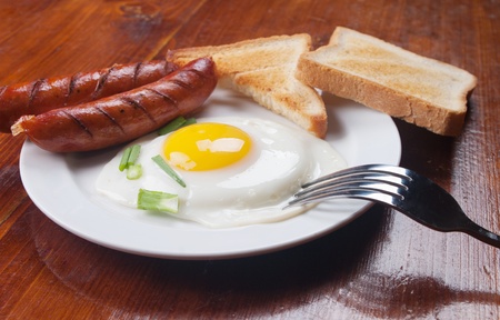 Breakfast - toasts, eggs and sausagesの写真素材