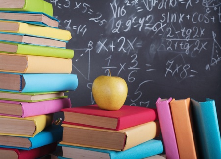 Books on the background of the school board の写真素材