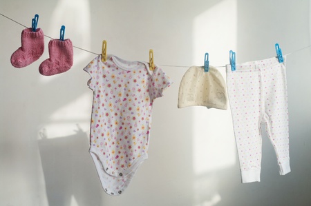 Baby laundry hanging on the rope の写真素材