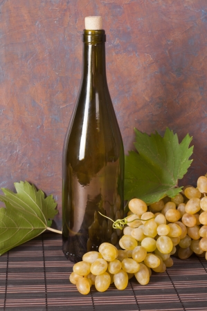 bottles of wine and ripe grapesの写真素材