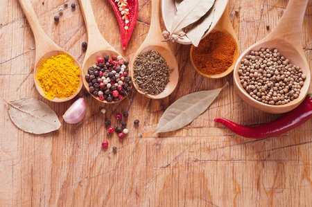 spices in the spoons on a wooden tableの写真素材