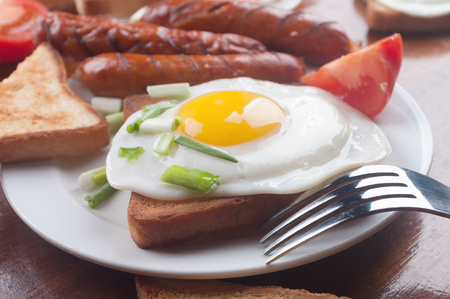 Breakfast - toasts, eggs and sausagesの写真素材