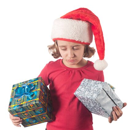 Little christmas girl wearing Santa hat. Isolated on white background.の写真素材