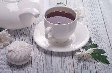 Tea cup served on wooden tableの写真素材