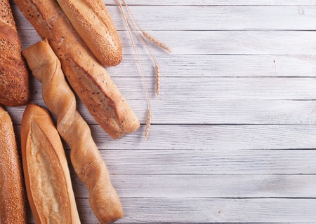 different types of baguette on a wooden background
