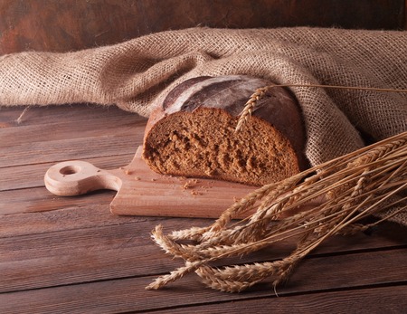 wheat and bread on a wooden tableの写真素材