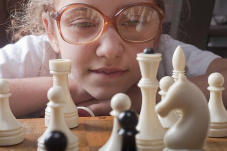 little girl plays chessの写真素材
