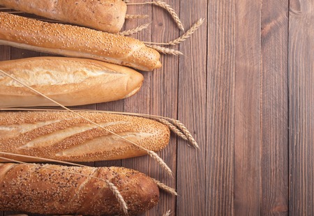 different types of baguette on a wooden background