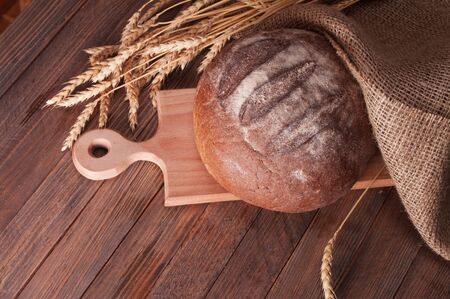 wheat and bread on a wooden tableの写真素材