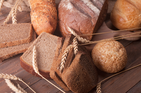different types of bread on a wooden tableの写真素材