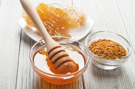 Still life with honey, honeycomb, pollenの写真素材