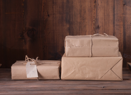 pile parcel wrapped with brown kraft paper and tied with twineの写真素材