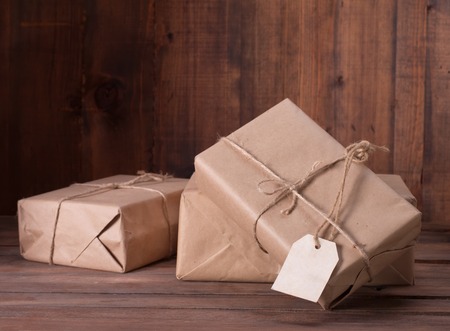 pile parcel wrapped with brown kraft paper and tied with twineの写真素材