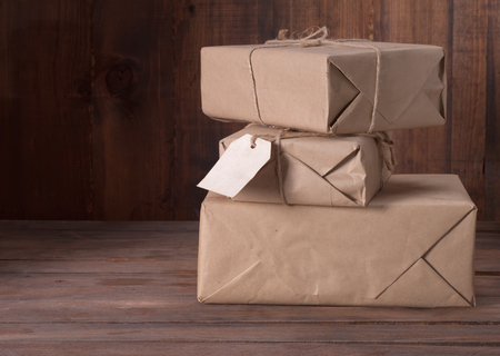 pile parcel wrapped with brown kraft paper and tied with twineの写真素材