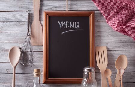 Blackboard on wooden surface and serving spoonsの写真素材