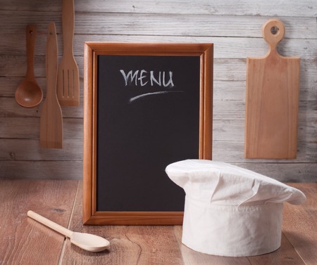 Blackboard on wooden surface and serving spoonsの写真素材