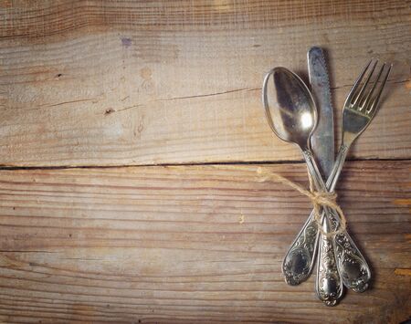 old cutlery on wooden tableの写真素材