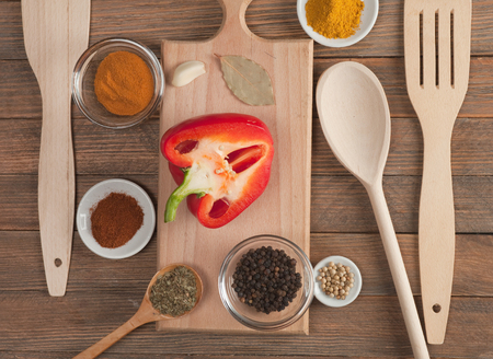 Various spices and vegetables on wooden tableの写真素材