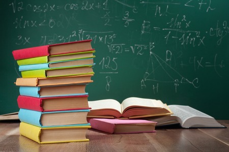 Books on the background of the school boardの写真素材