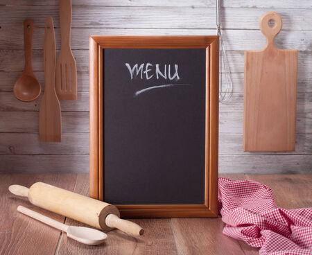 Blackboard on wooden surface and serving spoonsの写真素材