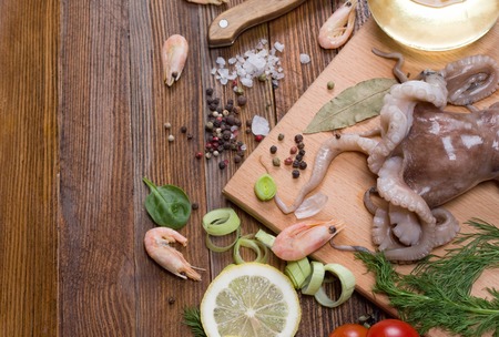 seafood and vegetables on a wooden backgroundの写真素材