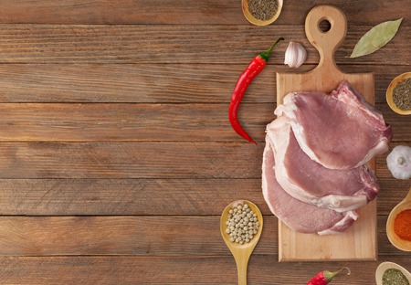 fresh raw meat prepared for cooking on woodの写真素材