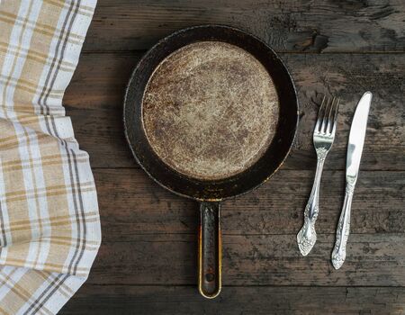Frying pan  on wooden table backgroundの写真素材