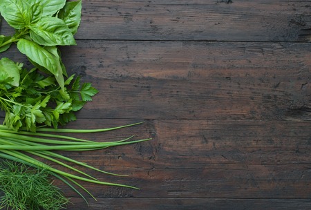 Parsley, dill, onion, basil on a wooden backgroundの写真素材