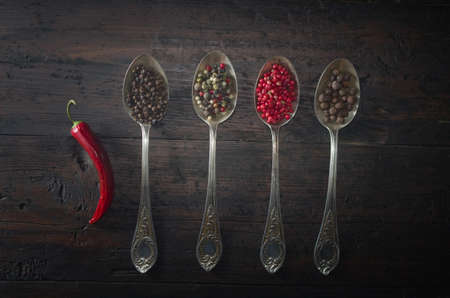 various types of pepper on a wooden backgroundの写真素材