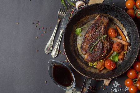 grilled steak with vegetables on a frying panの写真素材