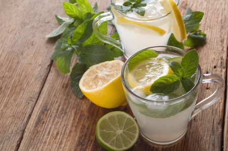 Cold fresh lemonade drink on a wooden backgroundの写真素材