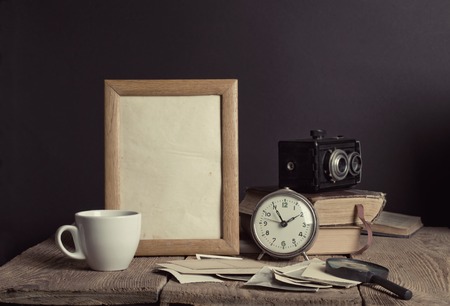 Still life with black vintage clock and photo framesの写真素材