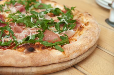 Pizza with prosciutto arugula and parmesan top view. Italian cuisine.の写真素材