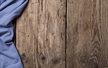 old wooden table with tablecloth backgroundの写真素材