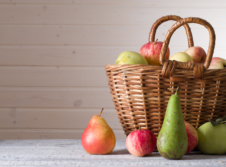 ripe pears and apples on wooden tableの写真素材
