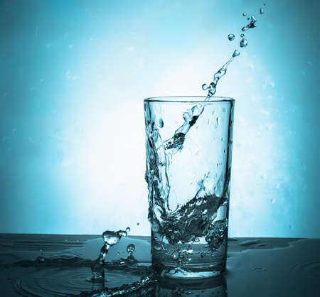 Water splash with drops from a glass