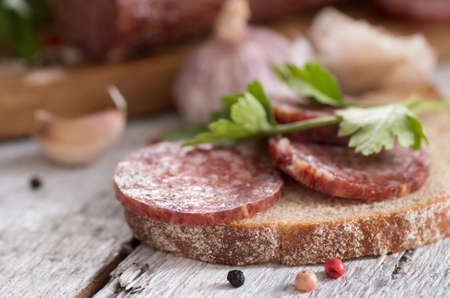 salami and bread on a wooden boardの写真素材
