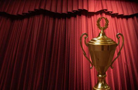 Gold winners trophy cup on a red backgroundの写真素材