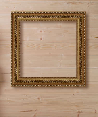 Gold picture frame hanging on the wallの写真素材