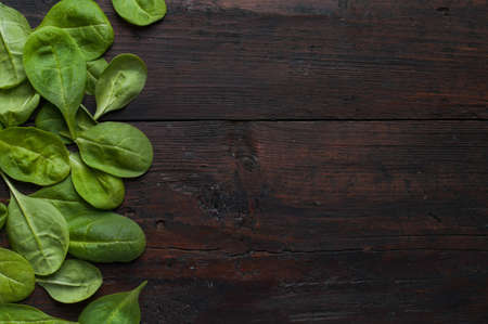 fresh green spinach on vintage wooden texture