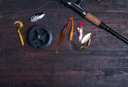 Accessories for fishing on the wooden backgroundの写真素材
