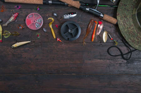 Accessories for fishing on the wooden backgroundの写真素材