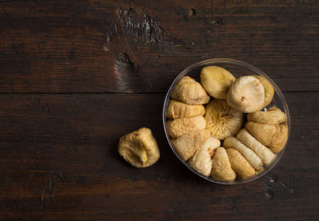 Dried figs on rustic wooden background