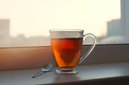 Cup of tea on a window sillの写真素材