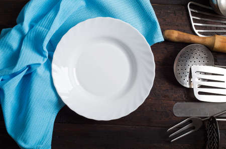 Vintage kitchen utensils on rustic wood background